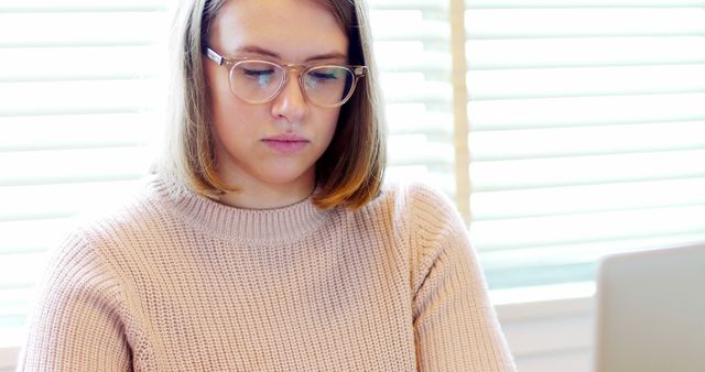 Focused Woman with Eyeglasses Working on Laptop in Bright Room - Download Free Stock Images Pikwizard.com