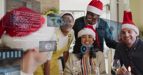 Young friends celebrating christmas dinner with augmented reality interface and santa hats