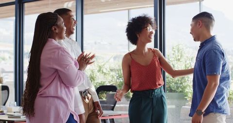 Colleagues Engaged in Lively Discussion in Contemporary Office