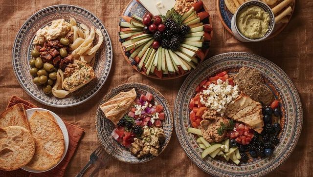 Featuring mediterranean mezze platters on patterned ceramic plates for communal sharing