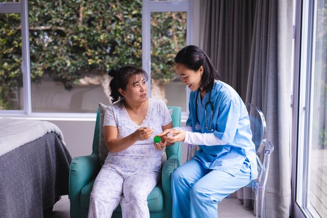 Asian Nurse Assisting Senior Woman with Medication - Download Free Stock Photos Pikwizard.com