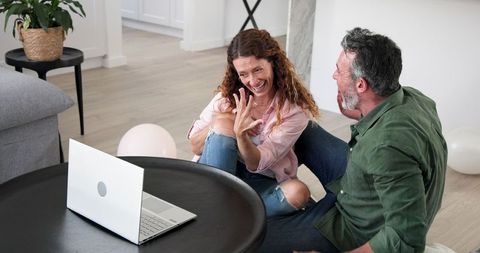 Happy Couple Celebrating Engagement with Online Video Call at Home