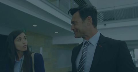 Business colleagues engaging in hallway discussion