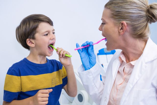 Dentist Teaching Boy Proper Brushing Technique - Download Free Stock Photos Pikwizard.com