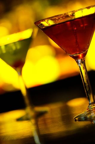 Two Colorful Cocktails Against Blurred Illuminated Background