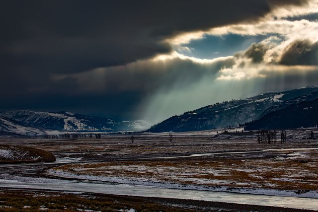 Dramatic Sun Rays Breaking Through Dark Clouds Over Snowy Landscape - Download Free Stock Photos Pikwizard.com