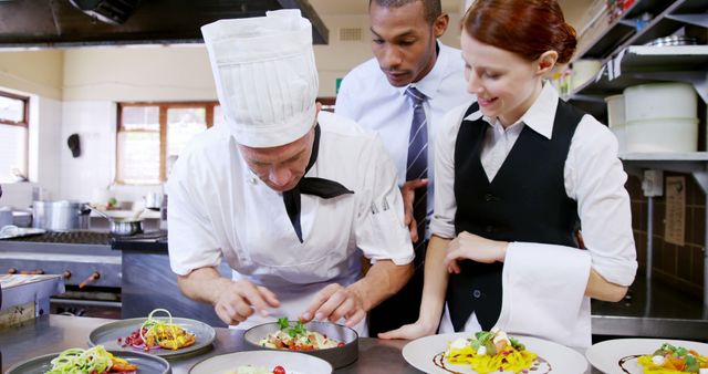 Professional Chef Preparing Gourmet Dish with Assistants in Kitchen - Download Free Stock Images Pikwizard.com