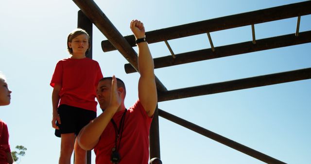 Coach Motivating Child on Outdoor Obstacle Course - Download Free Stock Images Pikwizard.com