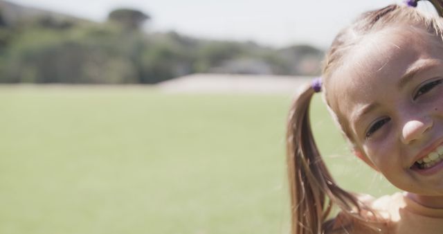 Smiling Schoolgirl with Pigtails in Outdoor Setting - Download Free Stock Images Pikwizard.com