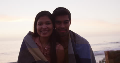 Romantic Couple Embracing by the Beach at Sunset