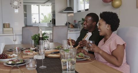 Friends Sharing a Healthy Lunch Around Dining Table