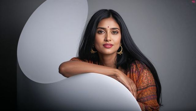 Elegant indian woman posing with confidence in minimalist studio