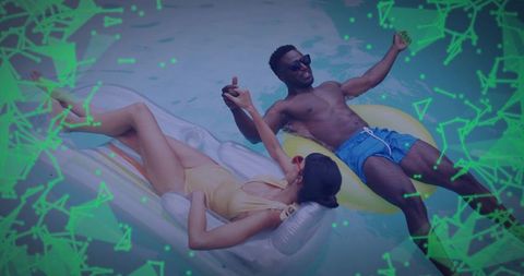 Happy Couple Relaxing on Pool Floats with Neon Green Overlay