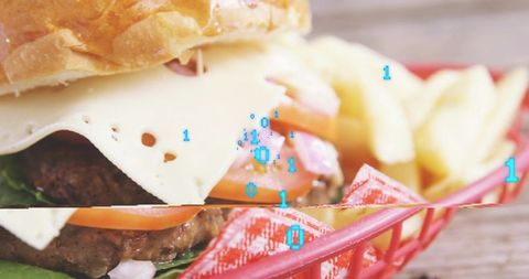 Glitching cheeseburger with swiss cheese and fries in red basket, digital overlay