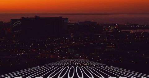 Curving binary data stream leading toward silhouetted city skyline at twilight harbor