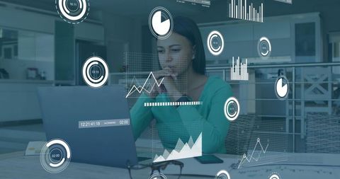 Woman analyzing laptop analytics with floating data overlays in open-plan kitchen office