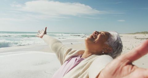 Joyful Senior Woman Relaxing on Sunny Beach - Download Free Stock Images Pikwizard.com