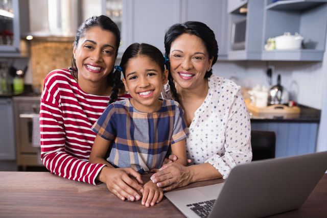 Three generations of women, including a grandmother, mother, and daughter, smiling and bonding in a modern kitchen. Ideal for use in family-oriented advertisements, articles on family values, or promotional materials for home and kitchen products.