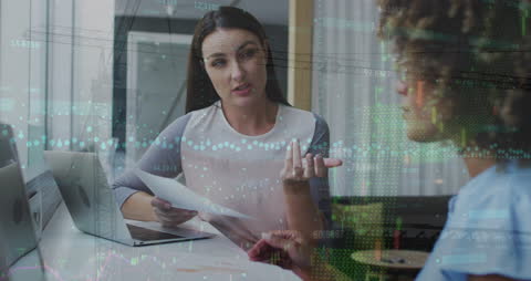 Business Meeting Overlaid with Financial Analytics and Fireworks