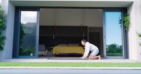 Asian Woman Preparing for Yoga on Modern Patio with Scenic Views