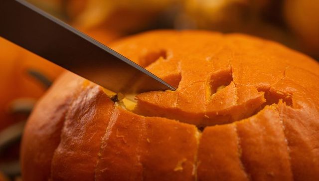 Crafting Jack-o'-lantern Face on Bright Orange Pumpkin