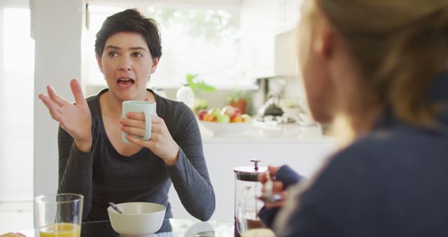 Two Women Discussing Over Breakfast in Contemporary Kitchen - Download Free Stock Images Pikwizard.com