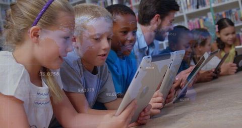 Schoolchildren Collaborating on Tablets in Modern Classroom Setting