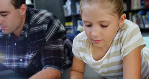 Father and Daughter Learning Together in Library