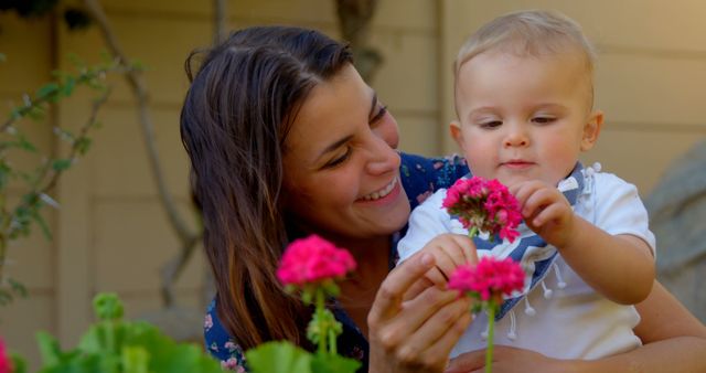 Mother With Toddler Son Exploring Flowers in Garden - Download Free Stock Images Pikwizard.com