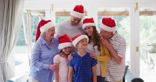 Family Celebrating Christmas in Living Room with Santa Hats - Download Free Stock Images Pikwizard.com