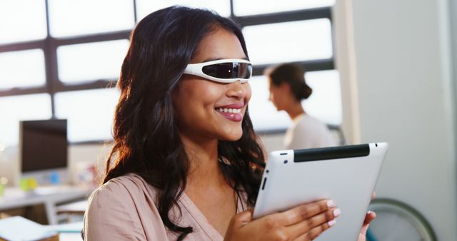 Woman using virtual reality glasses and digital tablet at office 4k