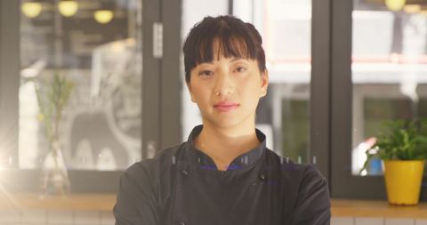 Chef standing confidently in cozy restaurant interior