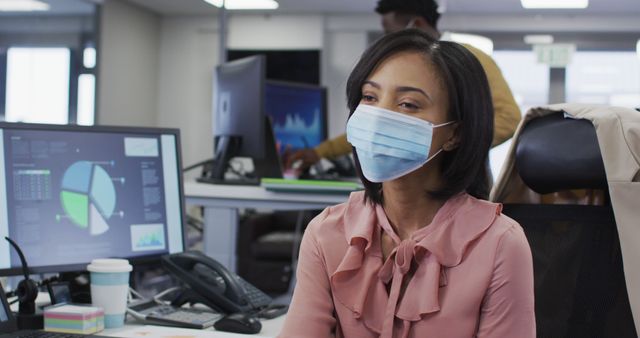 Businesswoman Wearing Face Mask at Office Desk - Download Free Stock Photos Pikwizard.com