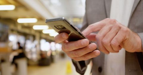 Businessman engaged in mobile communication