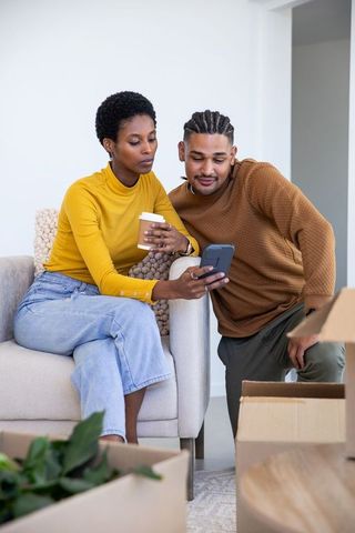 Couple Enjoying Relaxed Moment Unpacking New Home