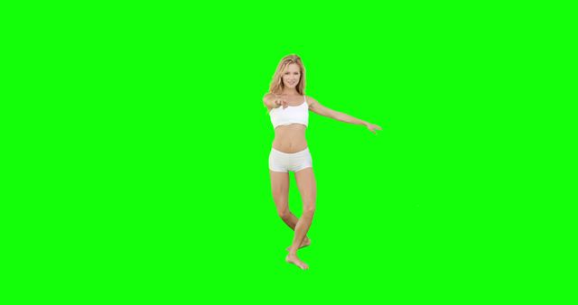 Young woman in athletic attire exercising against a green screen background. Includes pointing gesture, suggesting enthusiasm or engagement in fitness. Suitable for fitness promotions, health and wellness apps, exercise tutorials, and advertising related to active lifestyles.