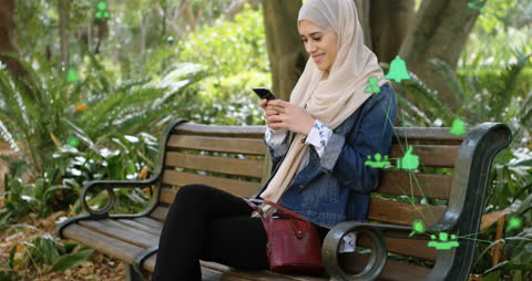 Tech-Savvy Woman in Hijab Using Smartphone for Networking