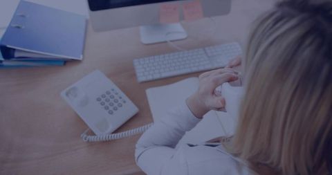 Businesswoman Talking on Corded Phone at Organized Desk Overhead View for Office Communication