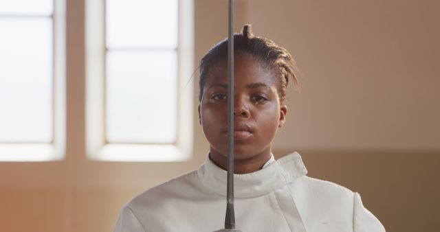 Determined Fencer Ready for Bout in Sunlit Gym - Download Free Stock Images Pikwizard.com