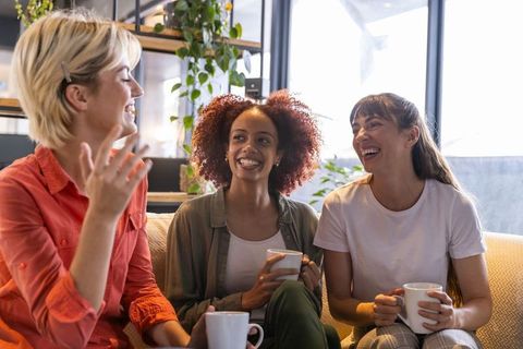 Diverse Female Friends Relaxing and Chatting Over Coffee