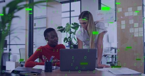 Female Coworkers Collaborating on Project with Laptop in Office