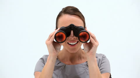 Joyful Woman Using Binoculars for Exploration