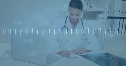 Doctor Analyzing Medical Data on Laptop and Paper Charts in Modern Office