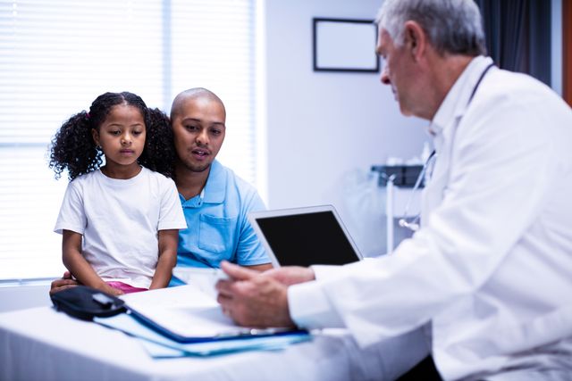 Doctor using digital tablet while interacting with patient - Download Free Stock Photos Pikwizard.com