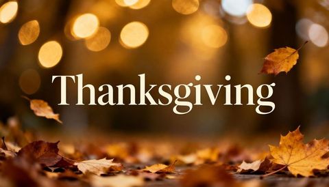 Thanksgiving Greeting with Floating Maple Leaves and Warm Golden Bokeh Background