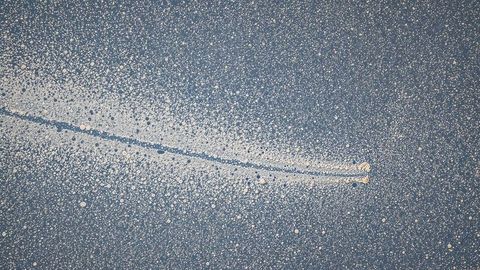 Motorboat Cutting Through Serene Blue Ocean Leaving Foamy Wake