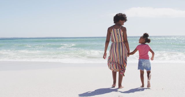 Mother and Daughter Holding Hands Walking on Sandy Beach - Download Free Stock Images Pikwizard.com