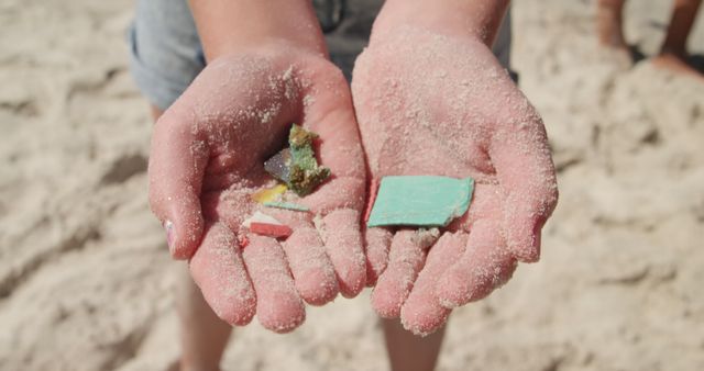 Person holding various pieces of litter found on the beach, demonstrating the issue of ocean pollution. This can be used in articles, blog posts, or campaigns related to environmental awareness, conservation efforts, and the impact of human activities on marine life.