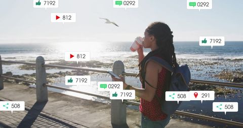Woman Engaging with Social Media Notifications by Seaside