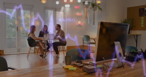 Team Analyzing Financial Data in Modern Office with Digital Graph Overlay